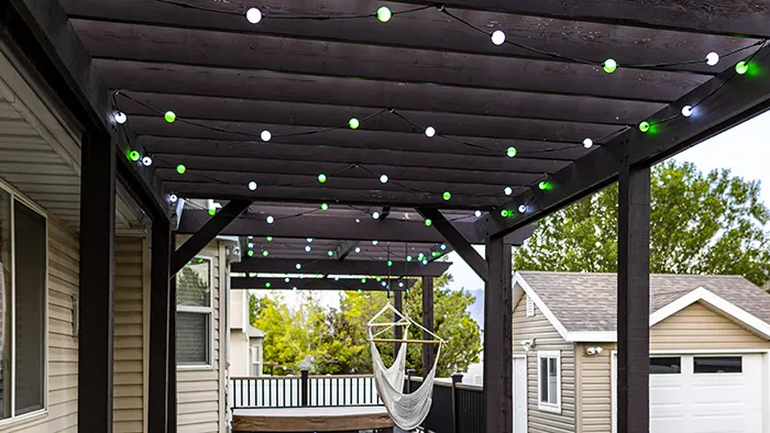 Globe lights hanging on a backyard pergola