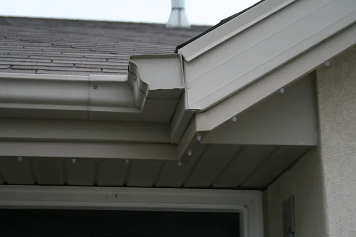 Low-profile light channel installed under a gutter