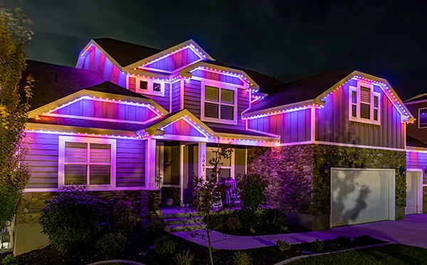 Pink and purple Valentine's Day lights on a two-story home
