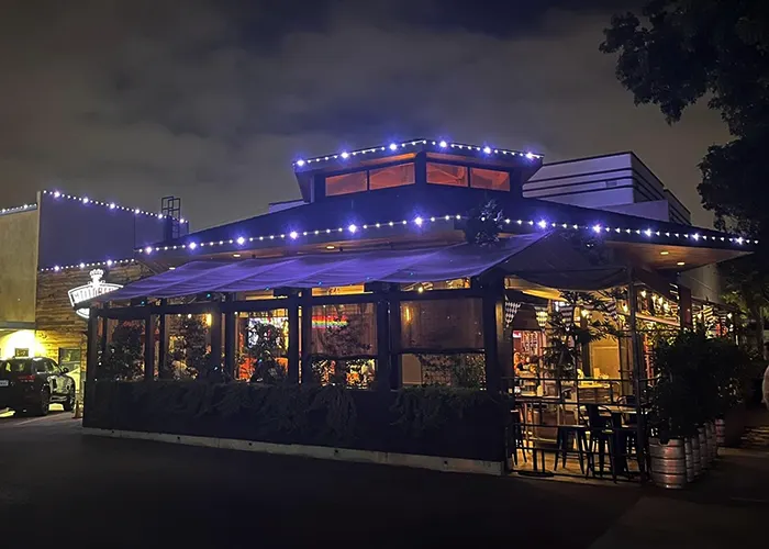 Restaurant patio outlined with permanent lights at night