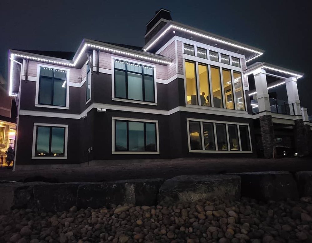 White permanent lights on a modern two-story home