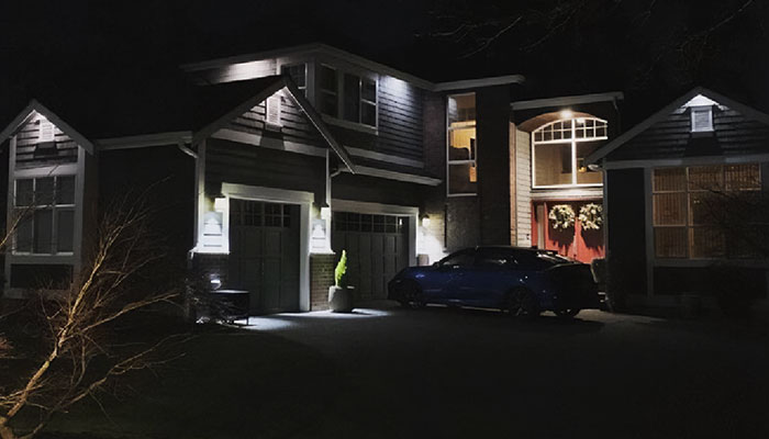 White security down lights over a home driveway at night
