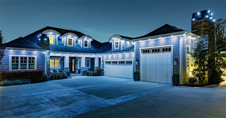 Blue and white permanent lights on a ranch home at dusk