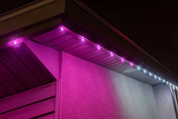 Close-up of pink and white lights under a soffit