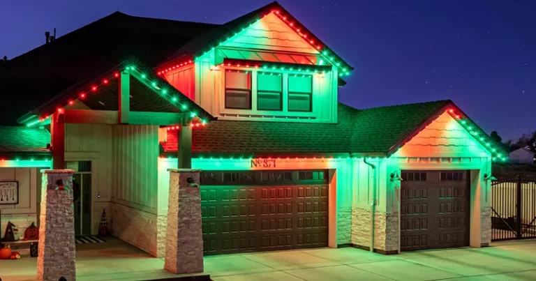 Red and green Christmas lights on a two-story home