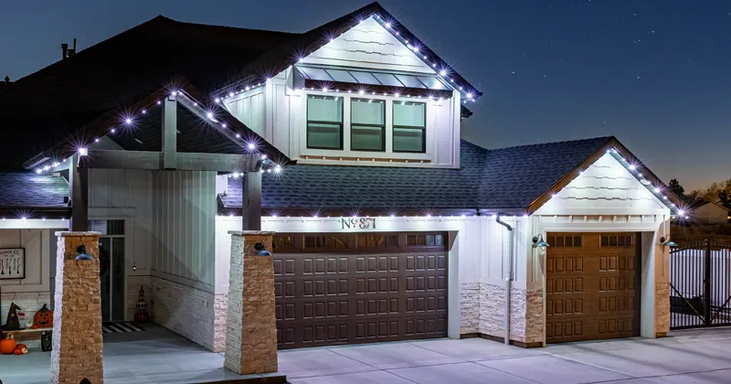 White permanent lights on a two-story home