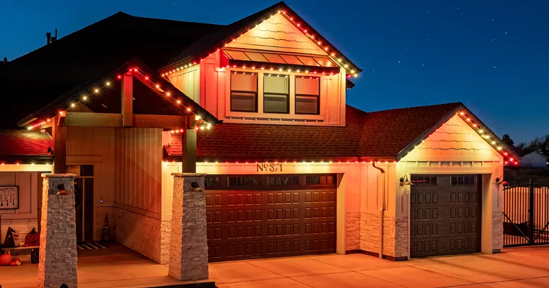 Warm autumn orange lights on a two-story home