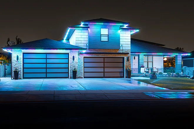 Teal and blue permanent lights on a modern home