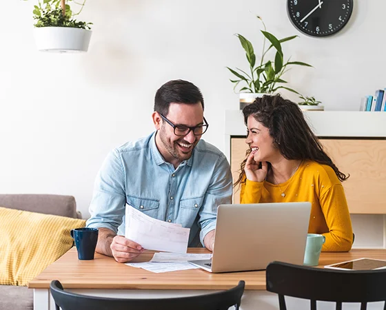 Couple reviewing energy savings on a laptop
