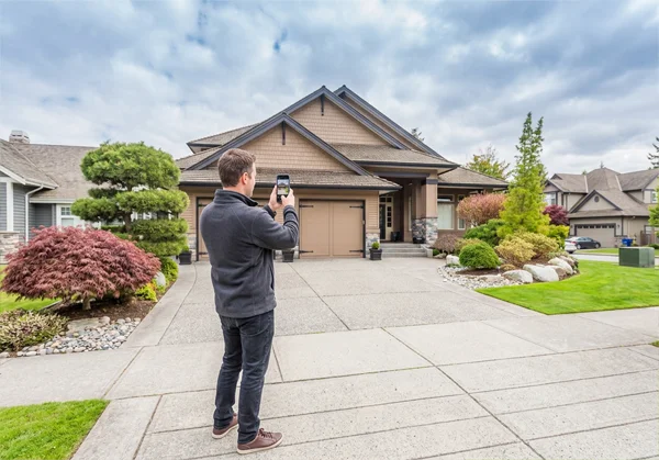 Man taking photo of trimlight home.webp
