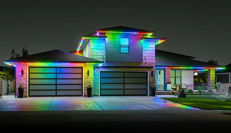 Rainbow permanent lights on a modern home at night