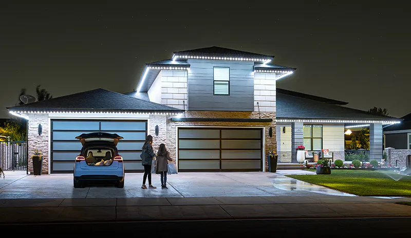 White security lights on a modern home with a family in the driveway